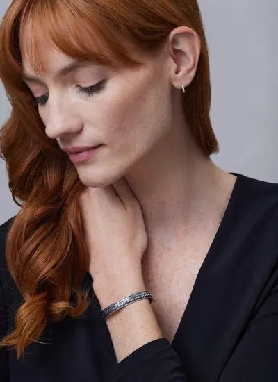 Red haired model wearing Sterling Silver Claddagh Cuff Bracelet with Cubic Zirconia